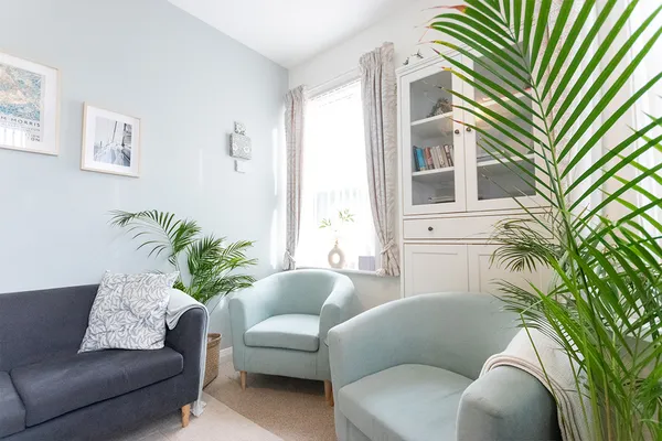 Lounge chairs behind a palm leaf
