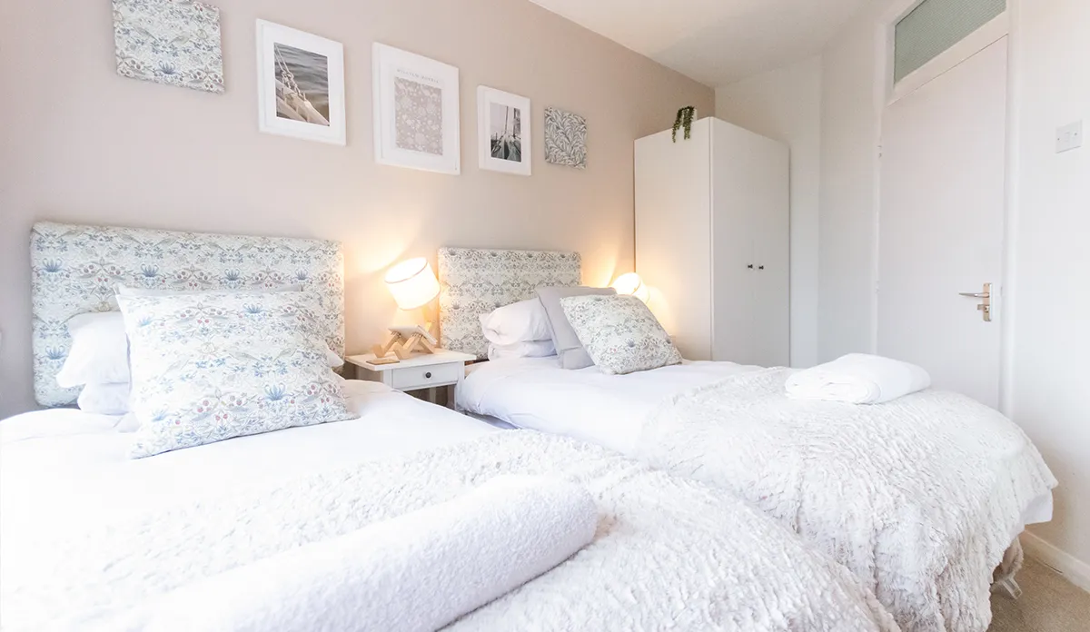 Two twin beds in a room at Poole Park House